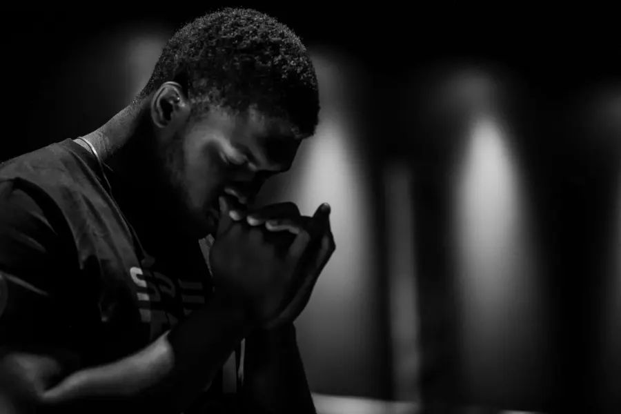 A man with his head bowed in prayer