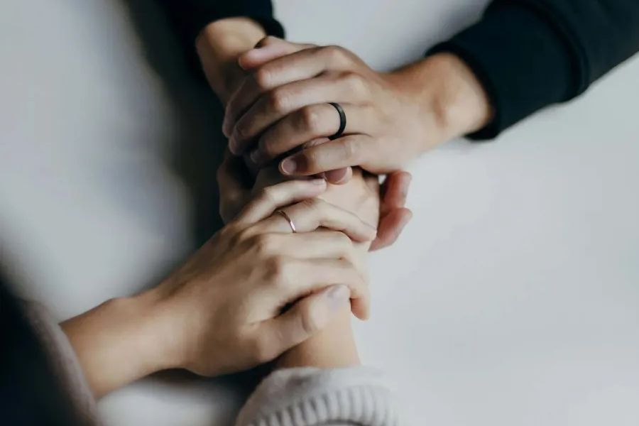 Hands held together in comfort